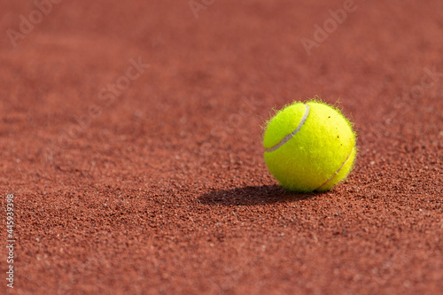 Tennis ball on a tennis clay court. Horizontal sport poster, greeting cards, headers, website © Augustas Cetkauskas