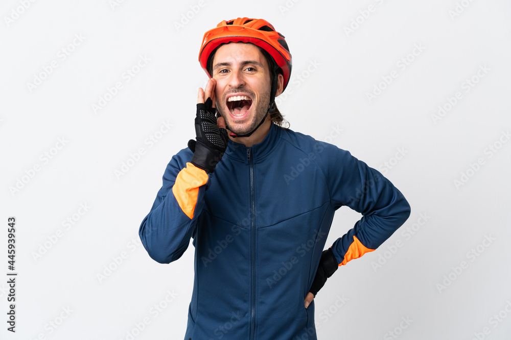 Young cyclist man isolated on white background shouting with mouth wide open