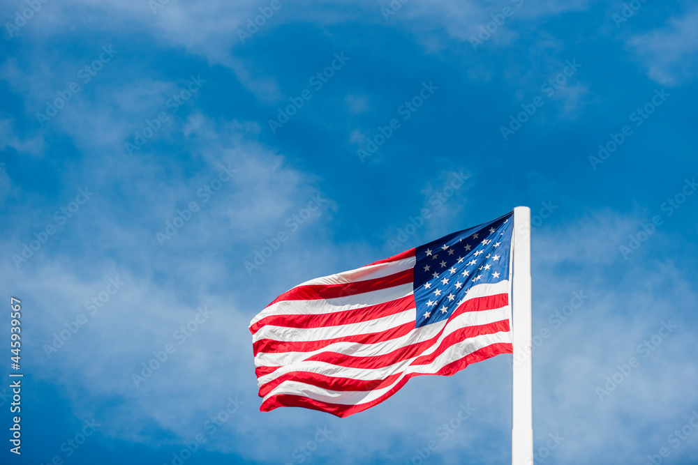 American flag on sky waving in the wind. Horizontal sport poster, greeting cards, headers, website
