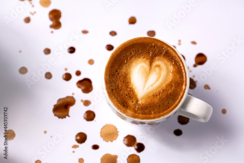 Heart shaped decoration on top of the espresso placed on white background