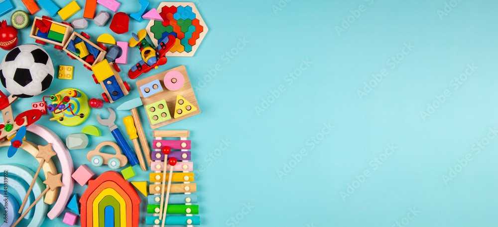 Baby kids toys on light blue background. Colorful educational wooden, plastic, fluffy and musical toys. Top view, flat lay - obrazy, fototapety, plakaty 