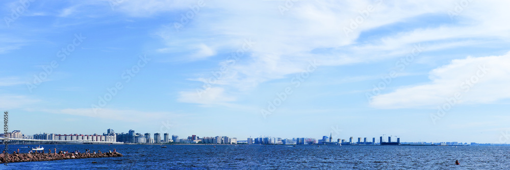 People are relaxing on a hot summer day. Panoramic view of Gulf of Finland, Neva Bay, people in Park of the 300th anniversary of St. Petersburg