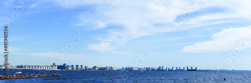 People are relaxing on a hot summer day. Panoramic view of Gulf of Finland, Neva Bay, people in Park of the 300th anniversary of St. Petersburg © ANGHI