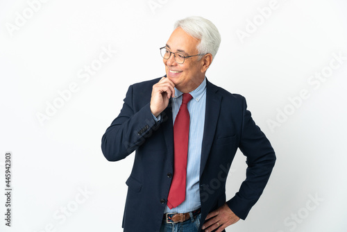 Middle age Brazilian business man isolated on white background looking to the side and smiling © luismolinero