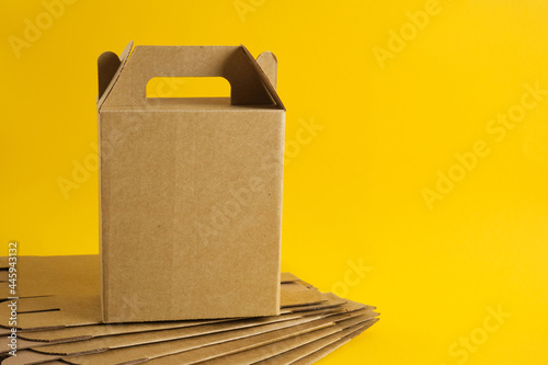 cardboard box on a yellow background, boxes for a gift without a logo, blank packaging for your design