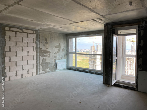 New apartment, new building without finishing and repair, with free planning and walls made of concrete, bricks and gas silicate blocks without partitions and with large panoramic windows