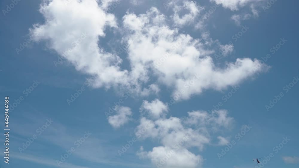 Bright white fluffy clouds slow fly across the beautiful sky on a sunny day. Bright white fluffy clouds slow fly across the beautiful sky on a sunny day.