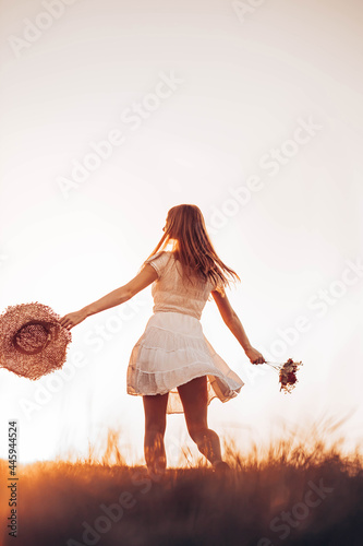 Canvas Print Outdoors photo of young, teen, ginger girl running through the field