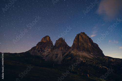 Night view of Sassolungo and Sassopiatto with clouds, stars and mist. Night landscape of Dolimites, Italy.