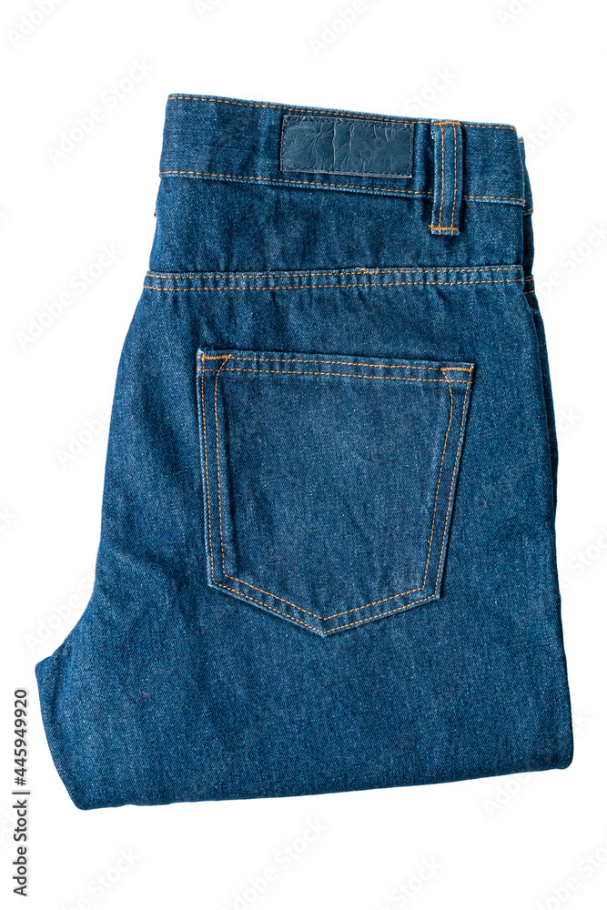 Folded jeans made of dark dense denim fabric, isolated on a white background, modern denim fashion Folded jeans made of dark dense denim fabric, isolated on a white background, modern denim fashion