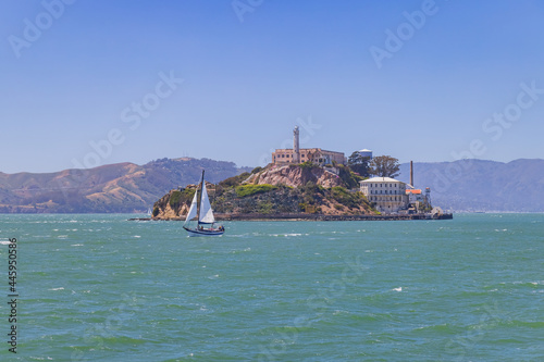 Sunny view of the Alcatraz Island and San Francisco Bay with a boat