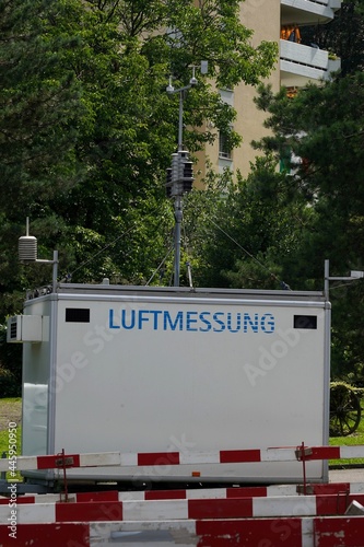 Mobile station for measuring of air quality in Switzerland. There is inscription in German language saying air measurement. It aims at monitoring of air pollution.  photo