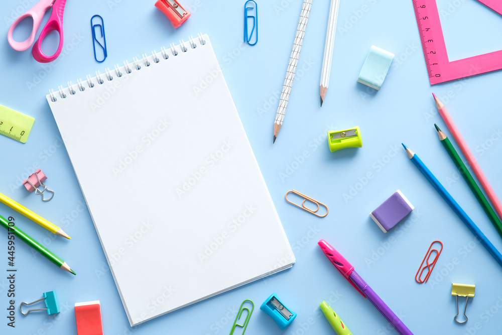 School stationery and notepad on blue background. Back to school concept. Flat lay, top view, overhead School stationery and notepad on blue background. Back to school concept. Flat lay, top view, overhead