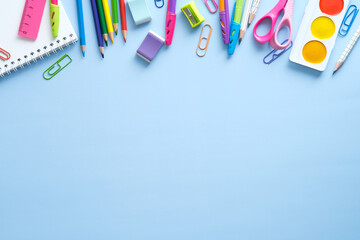 School stationery frame border top view. Back to school concept on blue background. Flat lay, view from above.