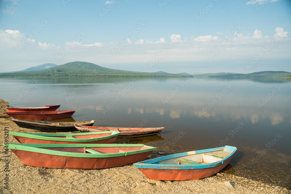 Old boats on the shore of a mountain lake