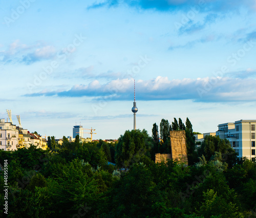 Fernsehturm at Berlin with some trees and architecture in the backgronud photo