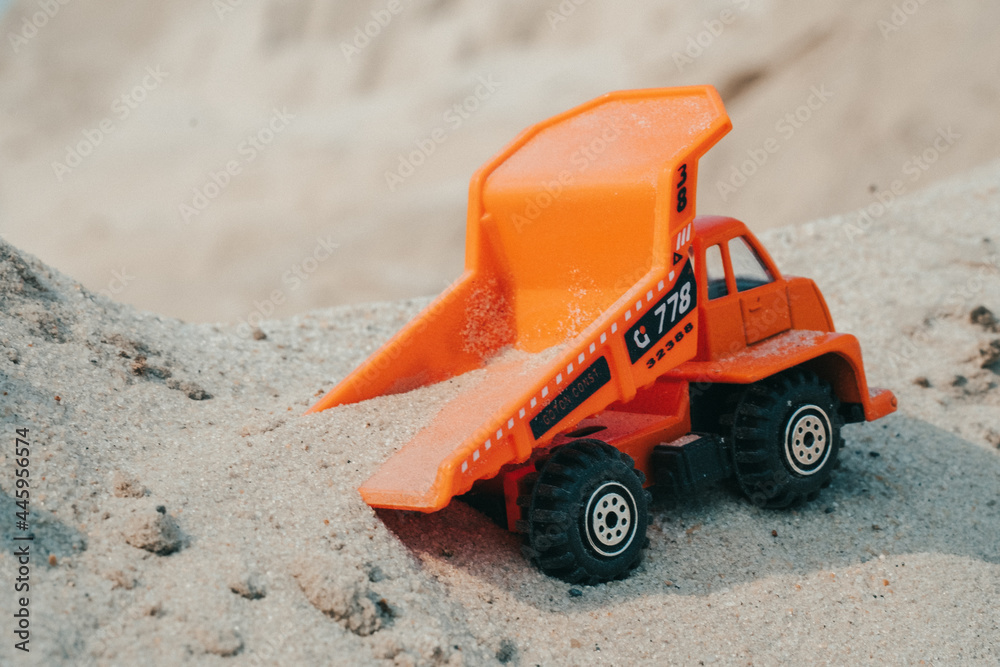 Truck in a sand quarry. Large excavator loads rock with iron or bauxite mining dump truck in a quarry against the sky Truck in a sand quarry. Large excavator loads rock with iron or bauxite mining dump truck in a quarry against the sky