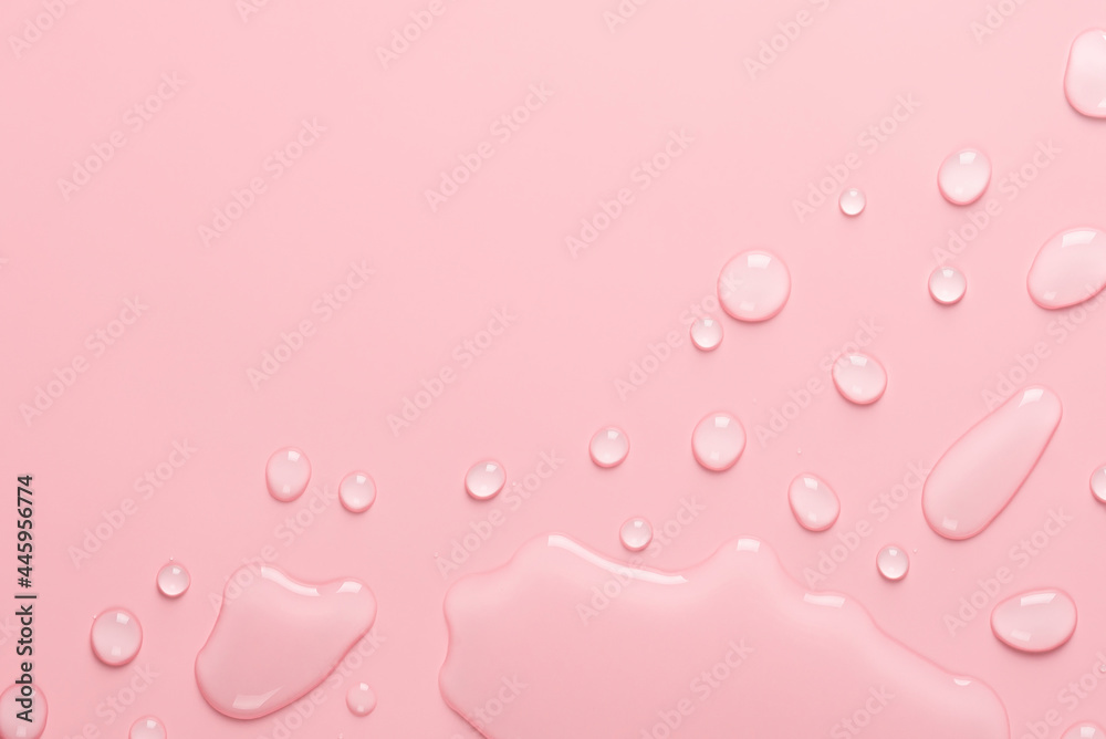 Splash of Water and drops on a pastel pink background. Water texture close up. Backdrop glass covered with drops of water. Water bubbles