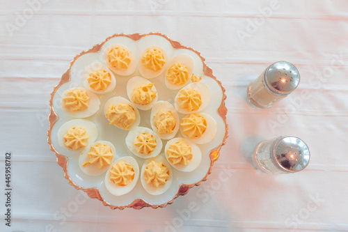 Deviled Eggs Arranged on a Plate With Salt and Pepper