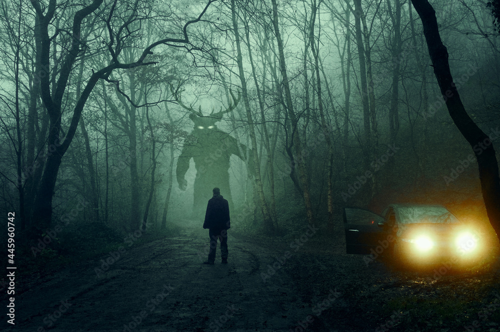 A horror concept. Of a man next to a car looking at a monster with glowing eyes. In a spooky, winter forest at night With a grunge, textured edit - obrazy, fototapety, plakaty 
