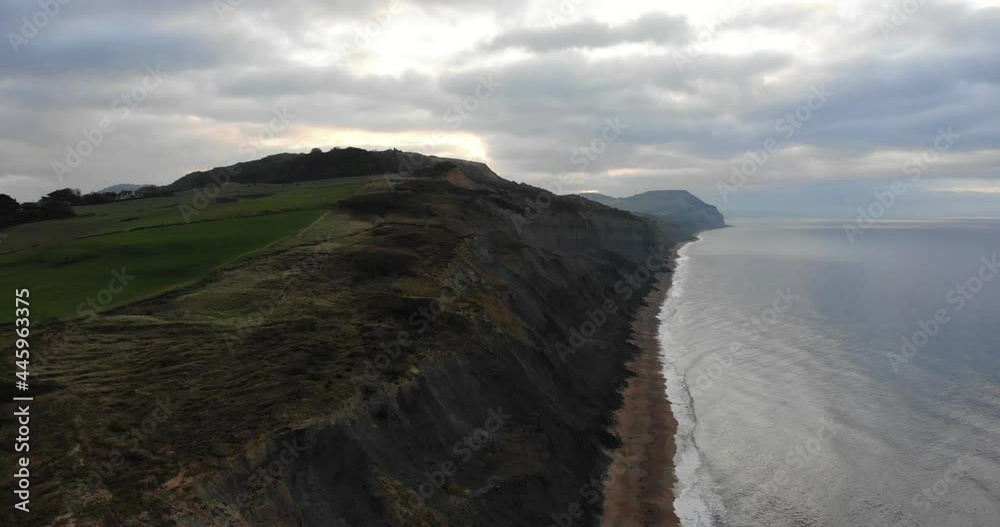 Aerial View Along Jurassic Coastline Cliffs Along Charmouth Beach In The Morning. Dolly Forward Aerial View Along Jurassic Coastline Cliffs Along Charmouth Beach In The Morning. Dolly Forward