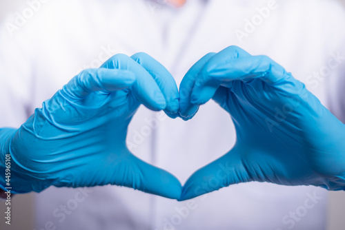 Close up of Doctor hands in gloves making shape of heart, Medicine and Healthcare Concept.