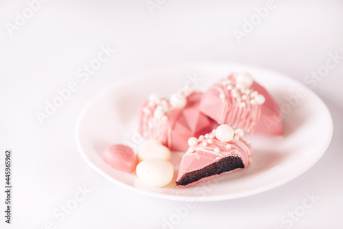 Pink heart-shaped cake on a plate. Gift for Valentine's Day and Women's Day