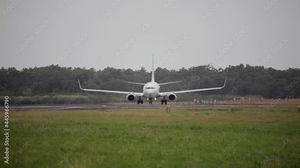Airplane (aircraft) is taxiing on a taxiway before takes off (taking off) at sunset Airplane (aircraft) is taxiing on a taxiway before takes off (taking off) at sunset