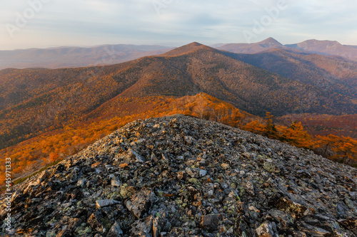 Sikhote-Alin Biosphere Reserve. The rocky slope of Mount Lysaya. See from above. Rocky ridge of a high mountain during a bright sunrise. photo