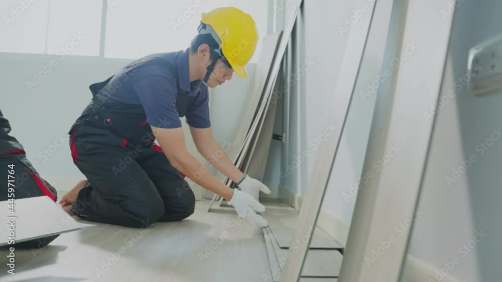 Slow motion of builder worker installs laminate board on floor at home Slow motion of builder worker installs laminate board on floor at home
