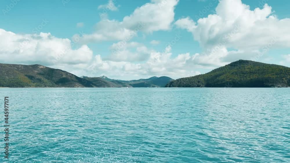 View from sailing past beautiful, lush, green islands on a sunny day. View from sailing past beautiful, lush, green islands on a sunny day.