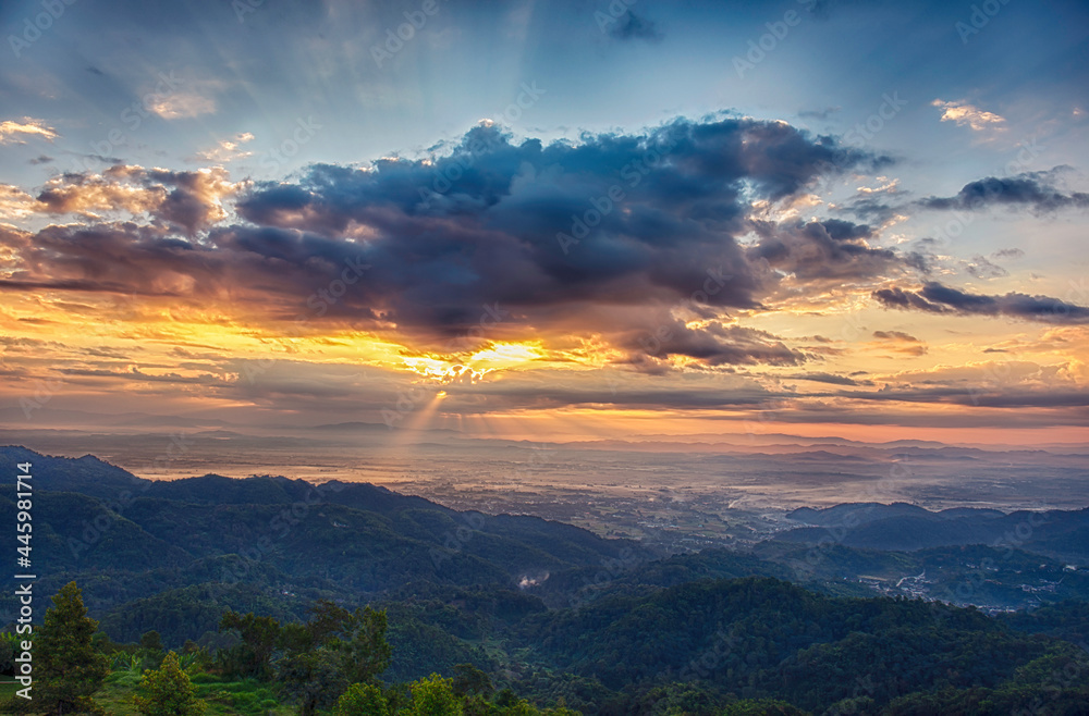 Sunrise landscape panoramic view with sun beams and misty at Chiang Rai province northern of Thailand