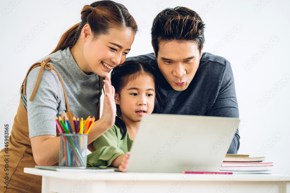 Portrait enjoy happy smiling love asian family father and mother with little asian girl learning and looking at laptop computer studying with online education e-learning system with teacher at home Portrait enjoy happy smiling love asian family father and mother with little asian girl learning and looking at laptop computer studying with online education e-learning system with teacher at home