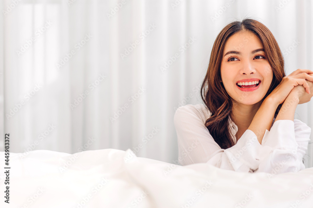 Portrait of smiling cheerful beautiful pretty asian woman clean fresh healthy white skin posing in pajamas white clothes.Girl felling relaxing and enjoy time on the bed at home.asia beauty Portrait of smiling cheerful beautiful pretty asian woman clean fresh healthy white skin posing in pajamas white clothes.Girl felling relaxing and enjoy time on the bed at home.asia beauty