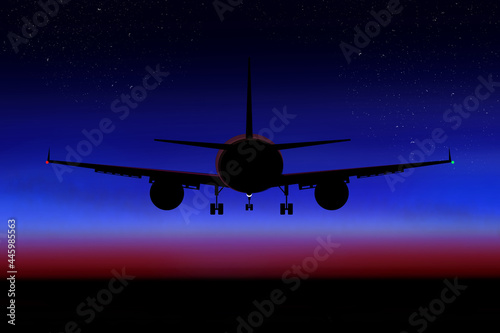 Airplane in the dark sky on the background of the sunset