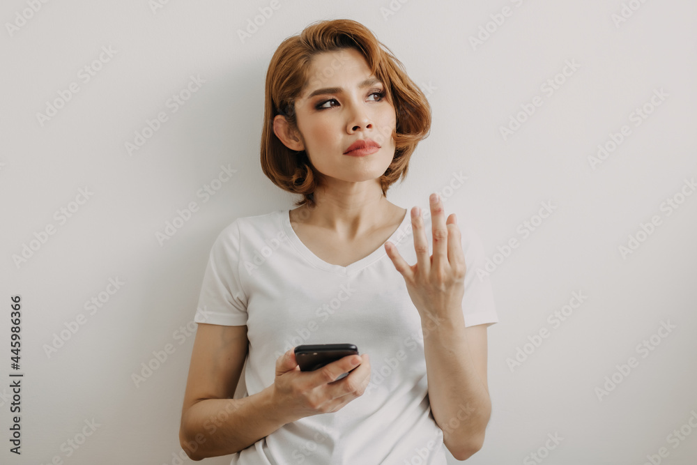 Asian woman resting and relax in the room with her smartphone in hand. Asian woman resting and relax in the room with her smartphone in hand.