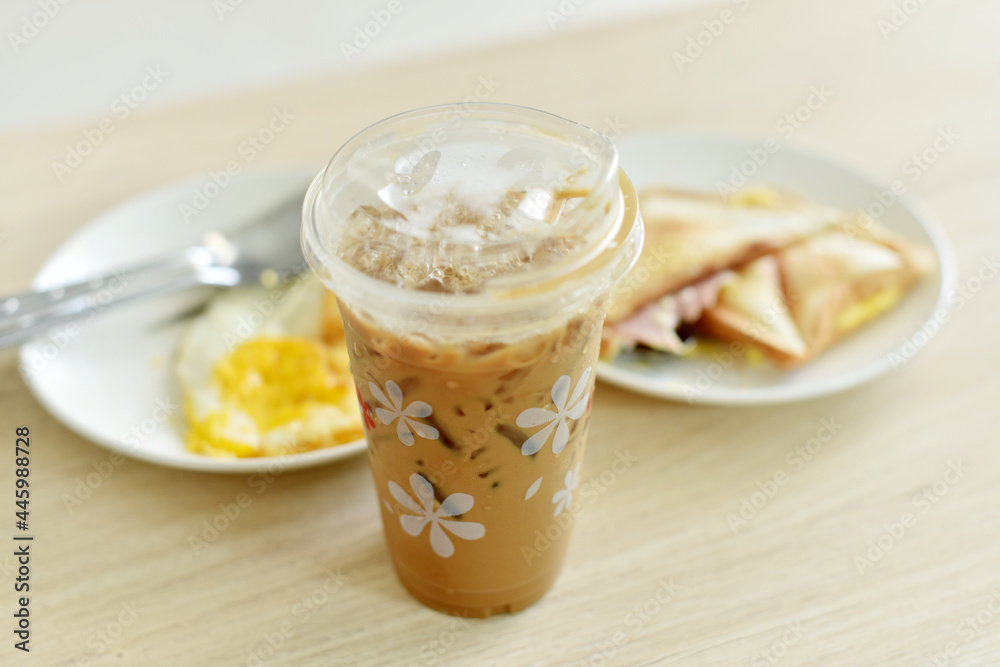 Iced coffee with breakfast on wooden table. Iced coffee with breakfast on wooden table.
