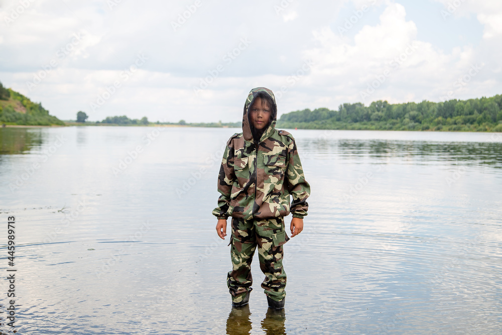 guy fisherman in a khaki suit with a mosquito net on the river guy fisherman in a khaki suit with a mosquito net on the river