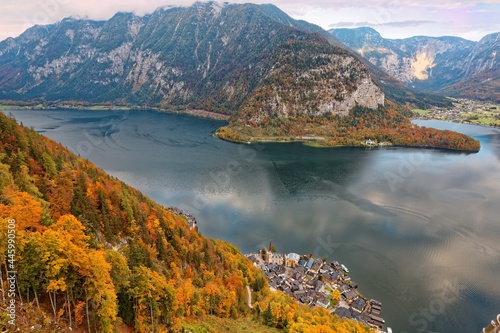 Aerial view of amazing Hallstatt and colorful fall mountains by the lake on a brisk autumn day, a peaceful lakeside village in Salzkammergut region of Austria