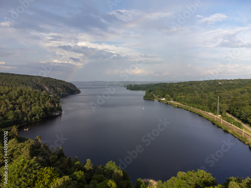 Beautiful view of a lake and forest. Aerial, drone photography from above taken in Sweden in summer time. Blue sky with clouds as background, copy space and place for text.