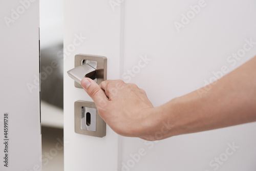 Фотография Woman open white door with a handle and entrance in the room