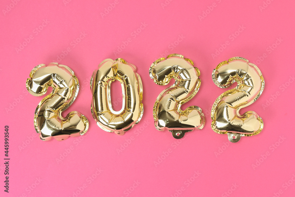 New Year 2022. Foil balloons numbers 2022 on a pink background. New Year Christmas. New Year 2022. Foil balloons numbers 2022 on a pink background. New Year Christmas.