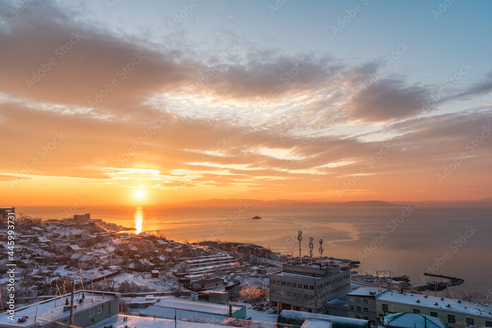 Sunset over a city covered in snow
