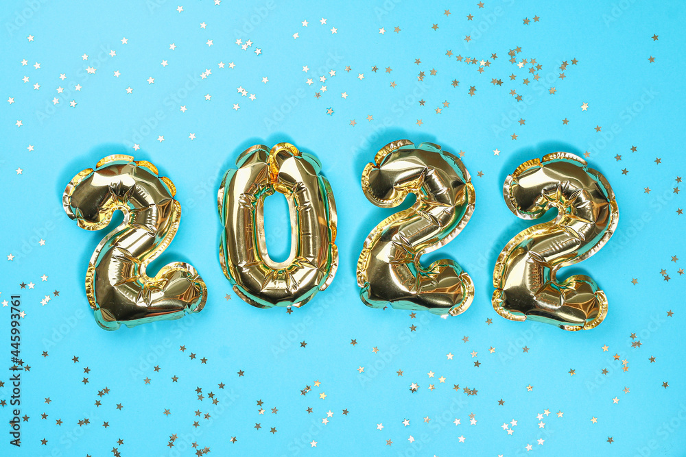 New Year 2022. Foil balloons numbers 2022 on a blue background. New Year Christmas. New Year 2022. Foil balloons numbers 2022 on a blue background. New Year Christmas.