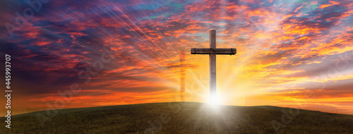 Wood cross of Jesus crucifixion and resurrection with bursting sunray background. Christianity and spiritual concept.