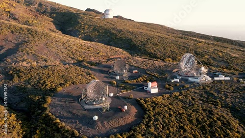 Aerial revealing shot of the Roque de Los Muchachos Observatory on La Palma, Canary Island, Spain with the view on the MAGIC (Major Atmospheric Gamma Imaging Cherenkov Telescopes) photo