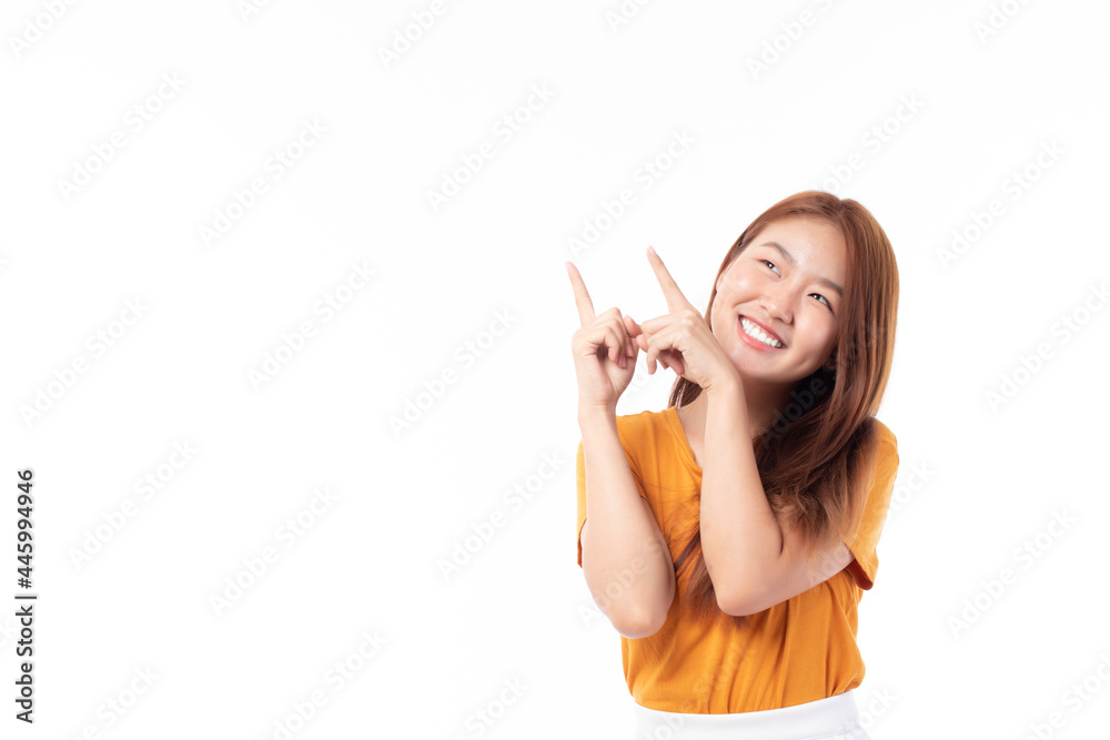 Beautiful Asian woman wearing casual clothes smile and pointing finger at copy space isolated on white background studio portrait.
