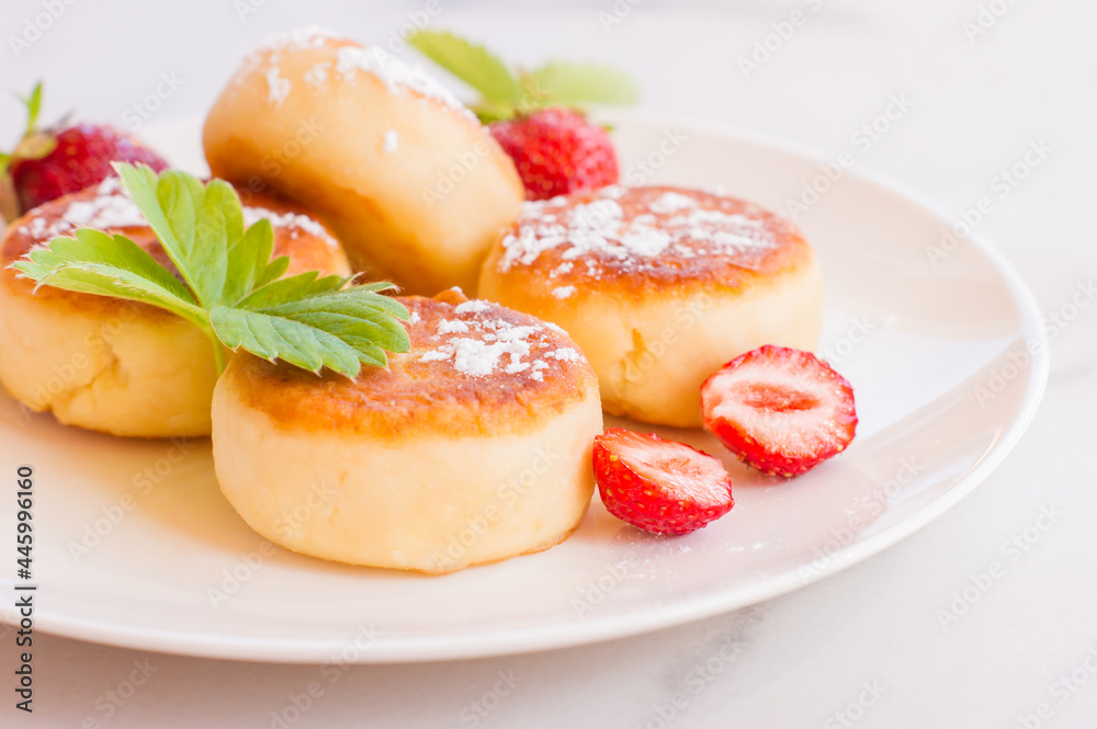 Sweet cheese pancakes on plate served strawberries and mint. Cottage cheese pancakes, syrniki, ricotta fritters, curd fritters. Sweet cheese pancakes on plate served strawberries and mint. Cottage cheese pancakes, syrniki, ricotta fritters, curd fritters.