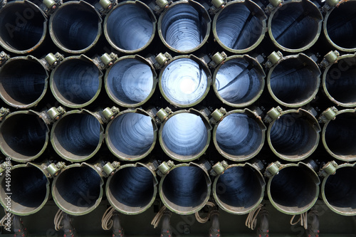 Pipes guiding flare launchers, background rows of pipes