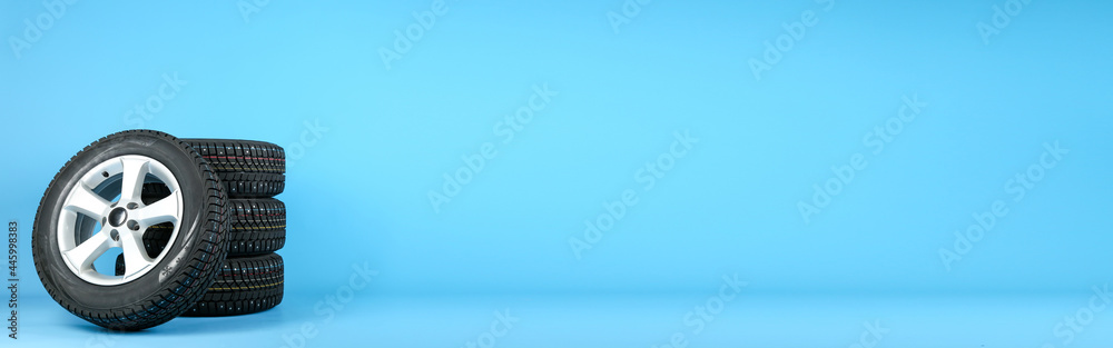 custom made wallpaper toronto digitalset of winter studded wheels are on a blue background with space for text. set of winter tires are on a blue background with copy space